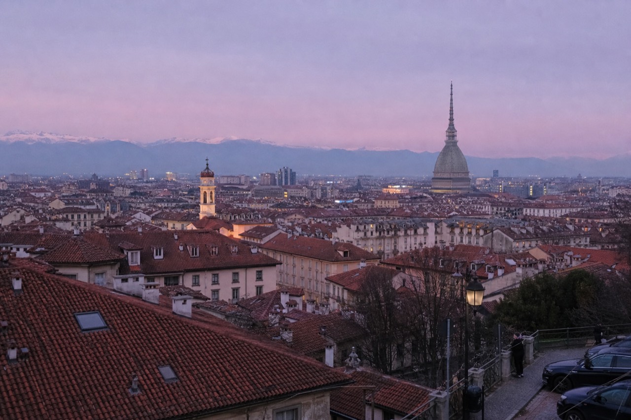 Turin's rooftops with the Mole Antonelliana rising above the city skyline.