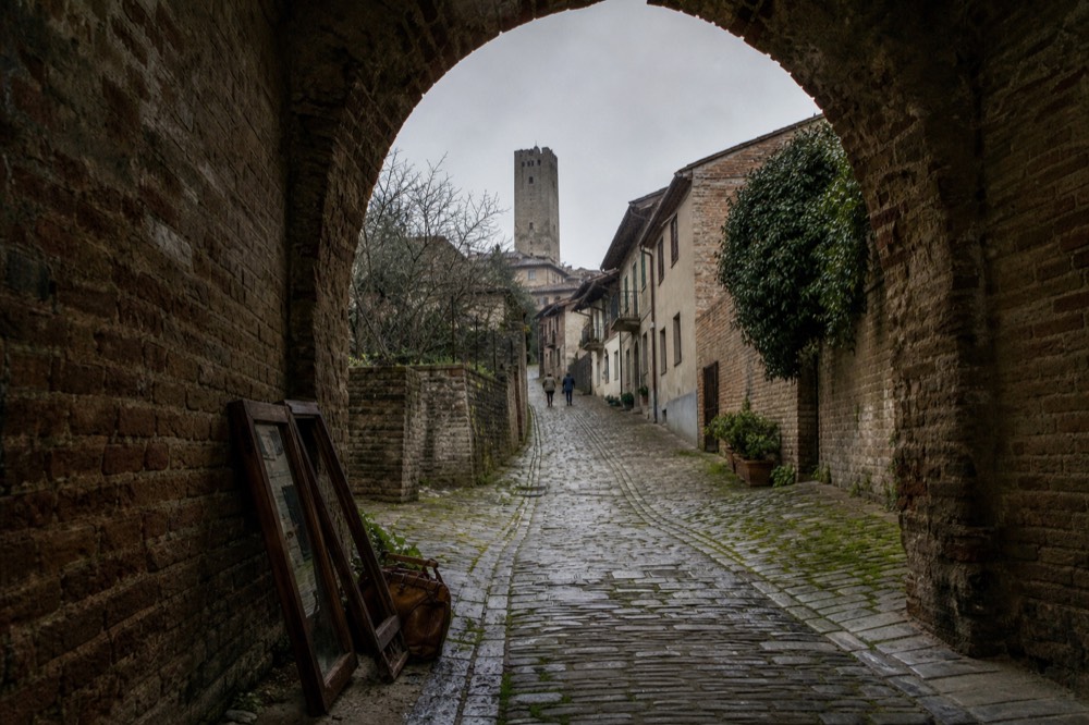 Two e-bikes on a cobbled lane in a Barbaresco village.